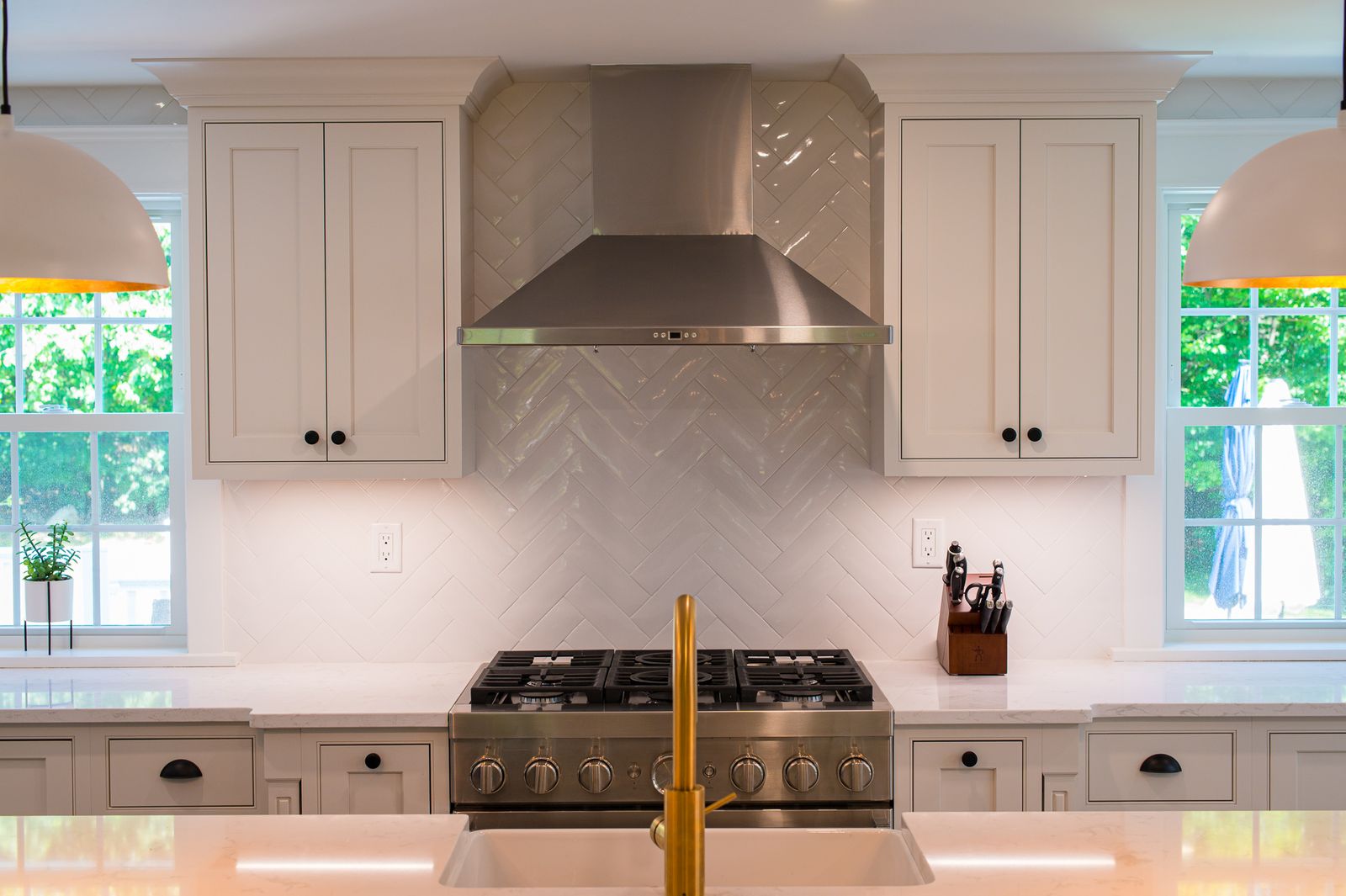 White inset kitchen with herringbone range wall