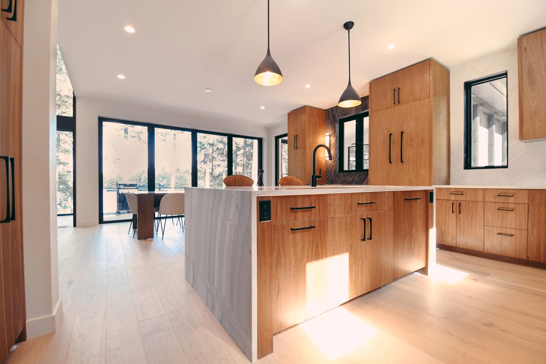 Walnut kitchen with quartzite waterfall island